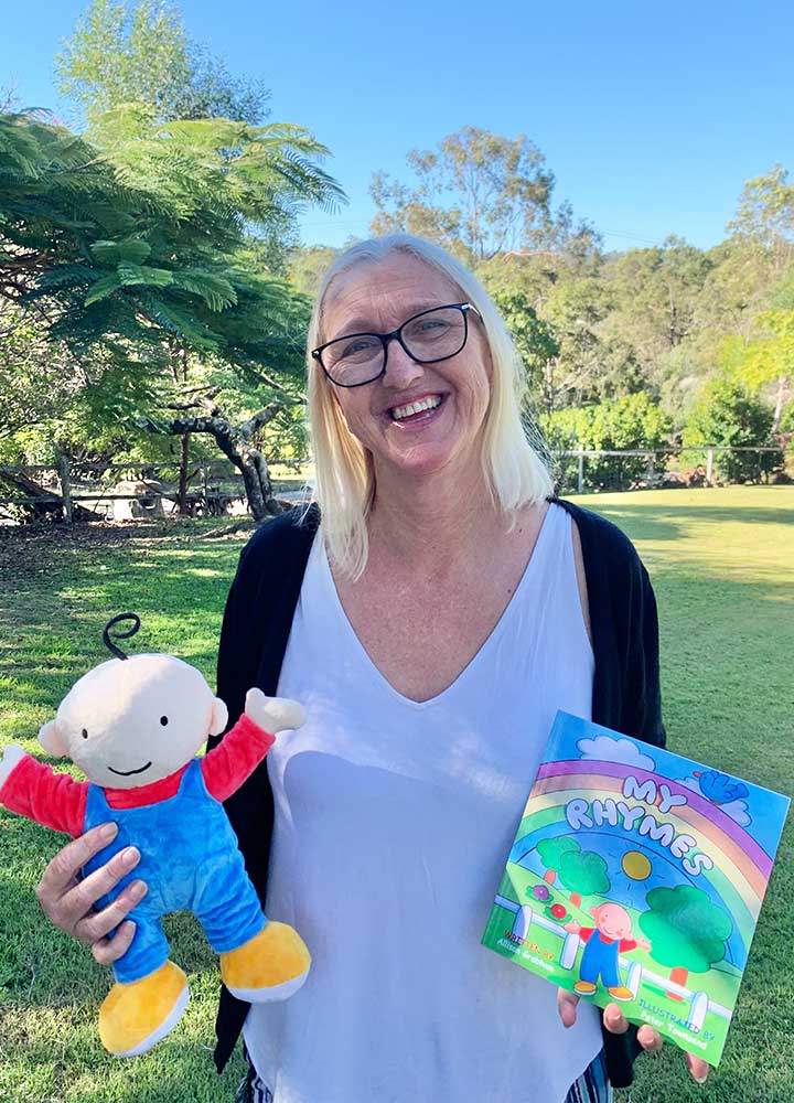 Author Allison Grabham holding her book My Rhymes and Danny Doll